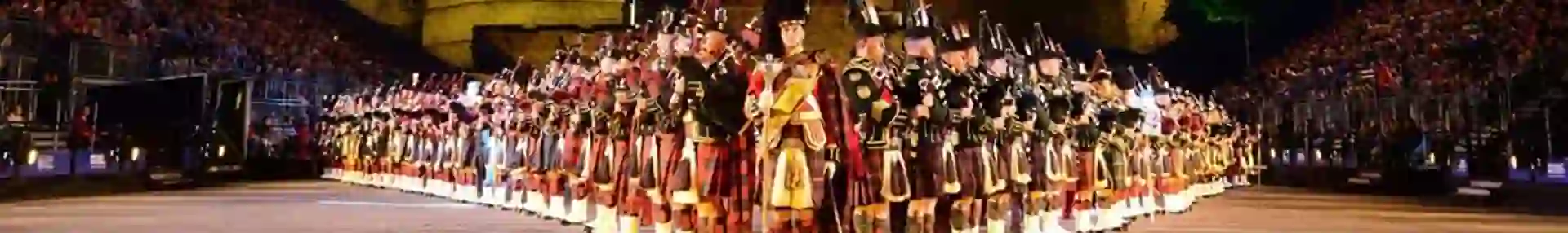 The Royal Edinburgh Military Tattoo lined up in formation infront of Edinburgh castle night time